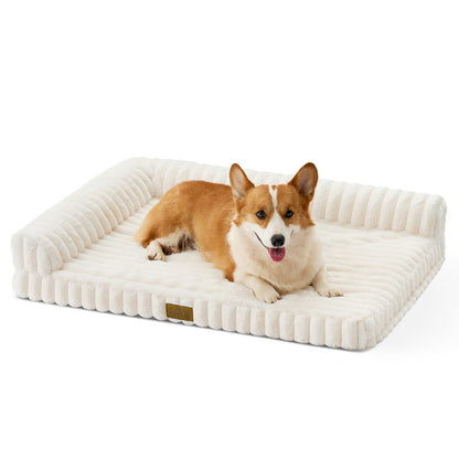Front view of a dog resting on the Cozy Kiss Striped Faux L-Shaped Washable Dog Bed, showing the raised bolster design. #color_Cream
