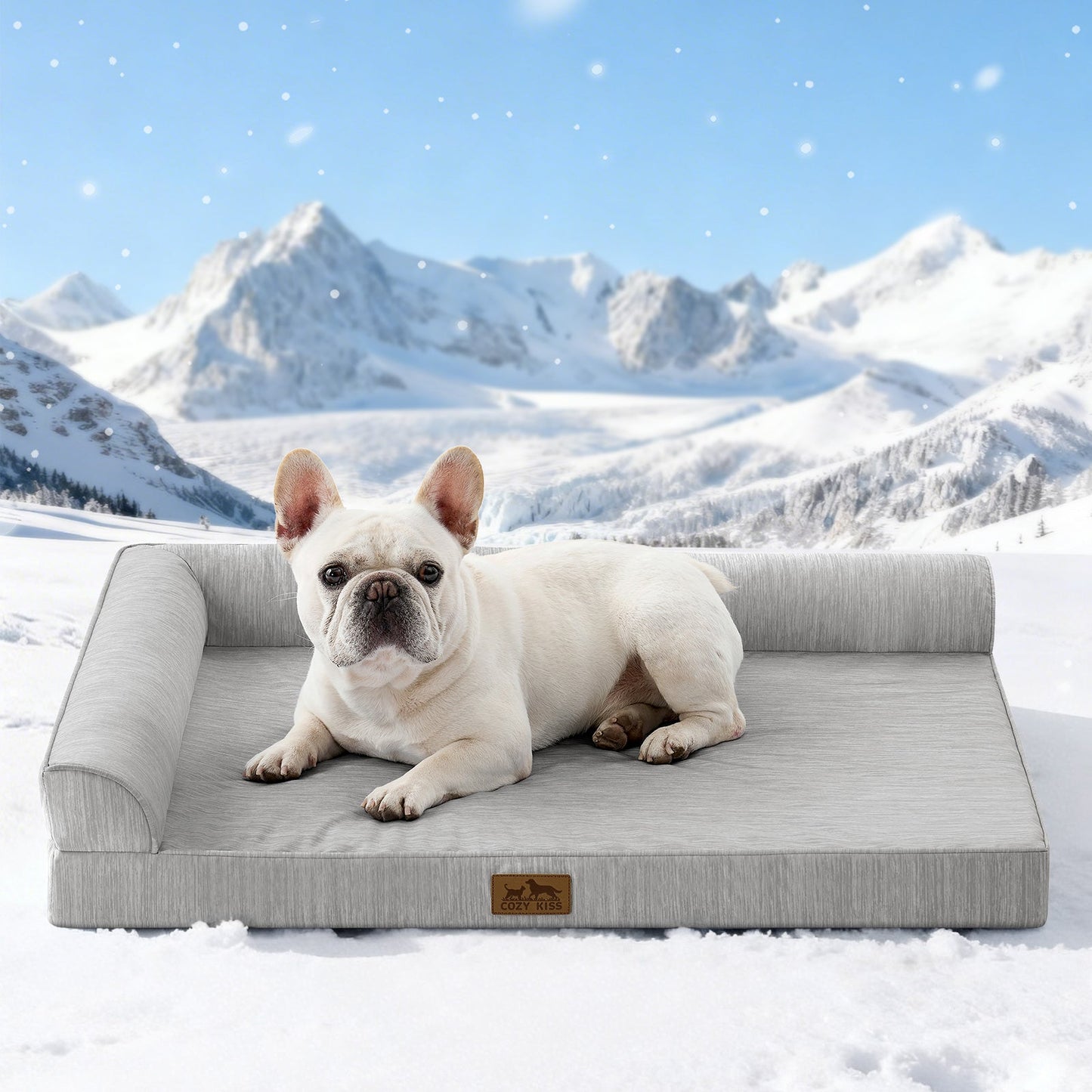 Dog lying on Cozy Kiss grey pet bed with a snowy mountain landscape in the background#color_Grey
