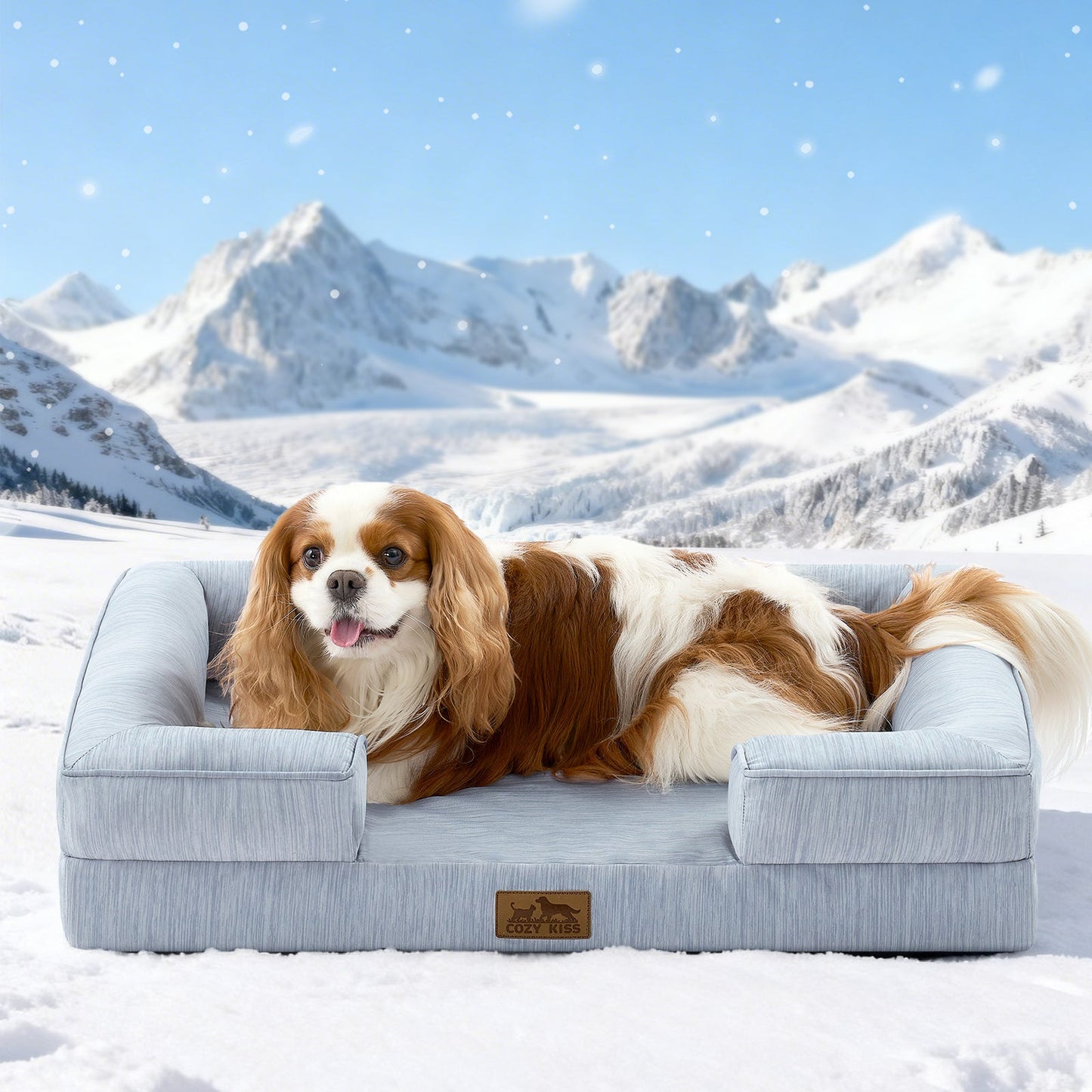 Dog lying on Cozy Kiss cool blue dog bed in a snowy landscape with mountains.#color_Sky Blue