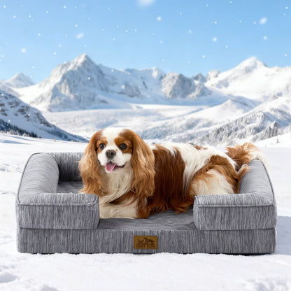 Dog lying on Cozy Kiss grey pet bed in a snowy landscape with mountains.#color_Dark Grey