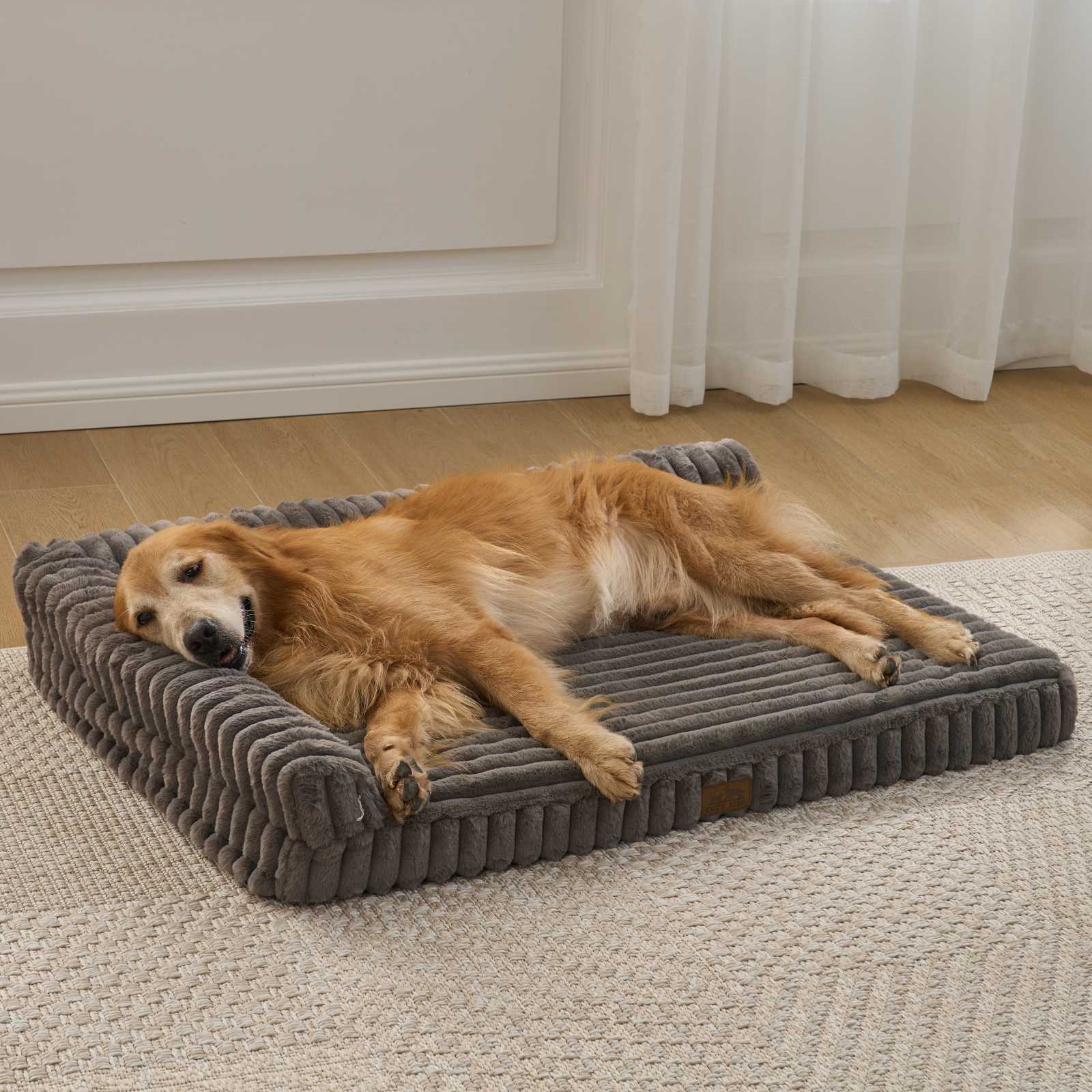 Front view of a dog resting on the Cozy Kiss Striped Faux L-Shaped Washable Dog Bed, showing the raised bolster design. #color_Dark Grey