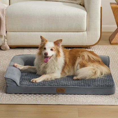 Cozy Kiss All Seasons L-shaped scratch-resistant dog bed in grey with a dog lounging in a bright living room#color_Grey