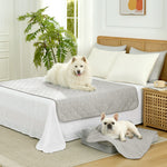 Cozy Kiss Diamond-Quilted Leakproof Cooling Couch Cover on bed with a dog sitting on it 
