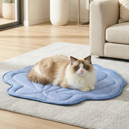 Cat sitting on Cozy Kiss blue shell shape cooling mat in a living room.#color_Blue