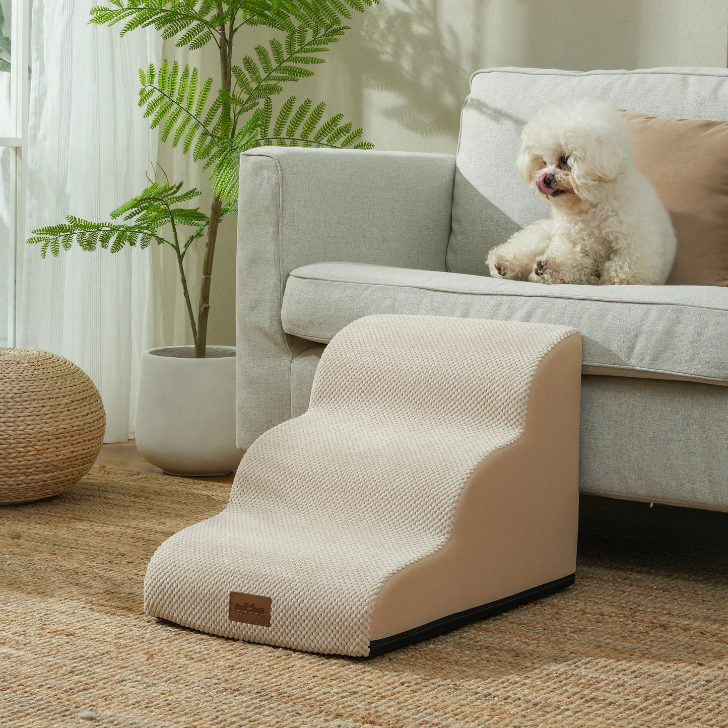 Cozy Kiss 3-Step Joint-Friendly Curved Pet Stairs with washable cover beside armchair helping small dog safely climb down #color_Beige