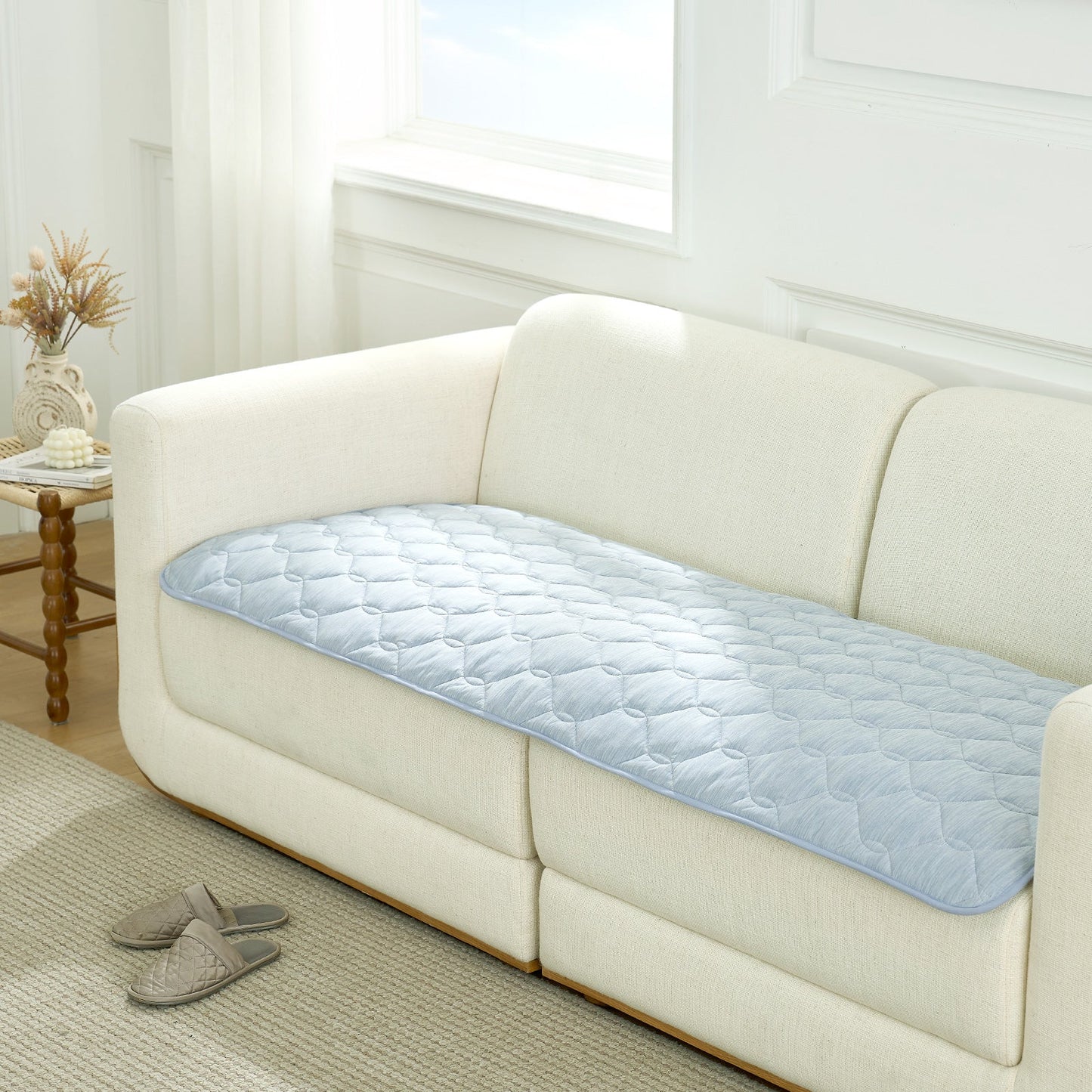 Cozy Kiss blue couch cover on a white sofa in a living room setting.#Color_Sky Blue