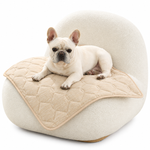 Dog lying on Cozy Kiss cooling mat on a white sofa in a cozy room.
