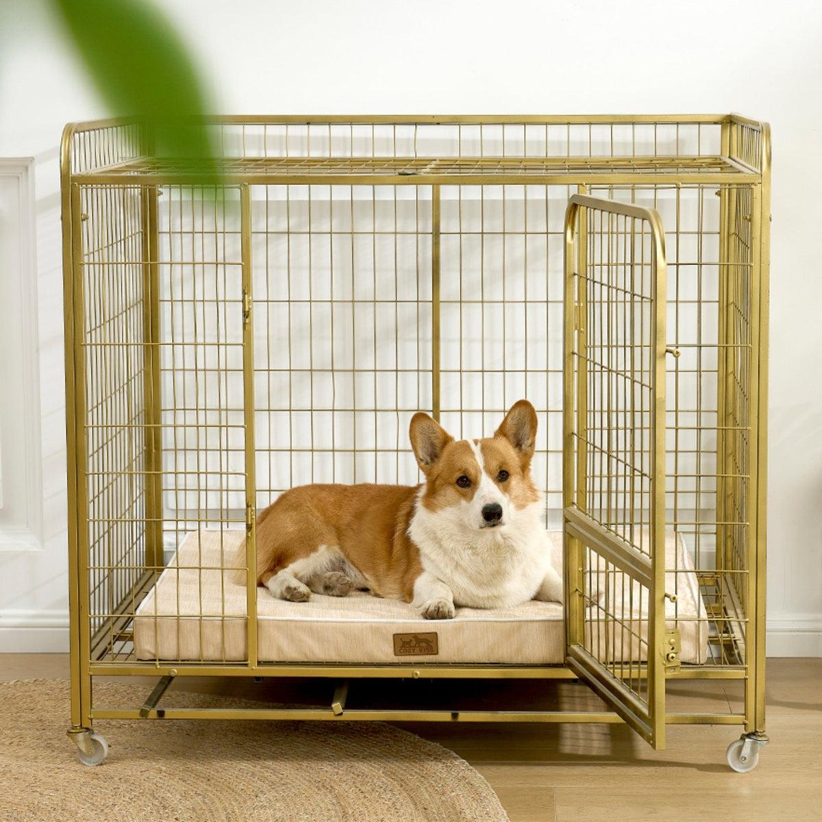Dog lying on a cooling cushion inside a gold metal dog crate.