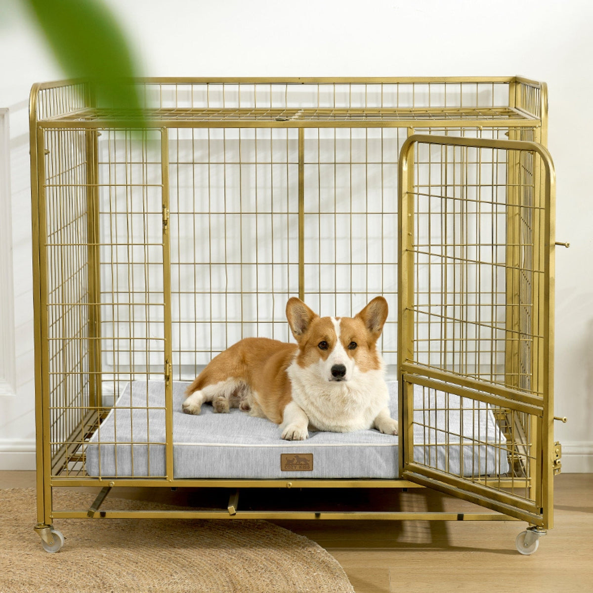 Dog lying on a cooling cushion inside a gold metal dog crate.