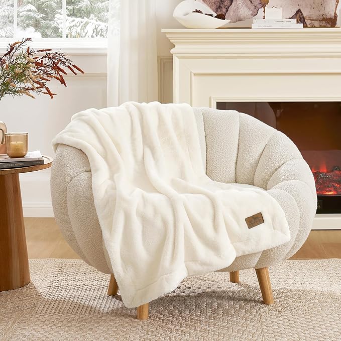 Cozy Kiss leakproof faux fur pet blanket draped over an armchair in a cozy living room setting. 