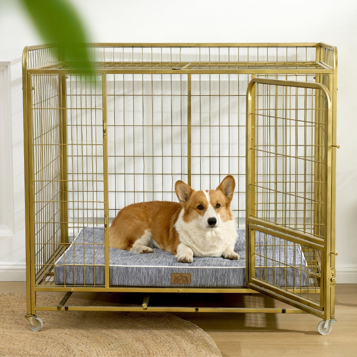 Dog lying on a cooling cushion inside a gold metal dog crate.