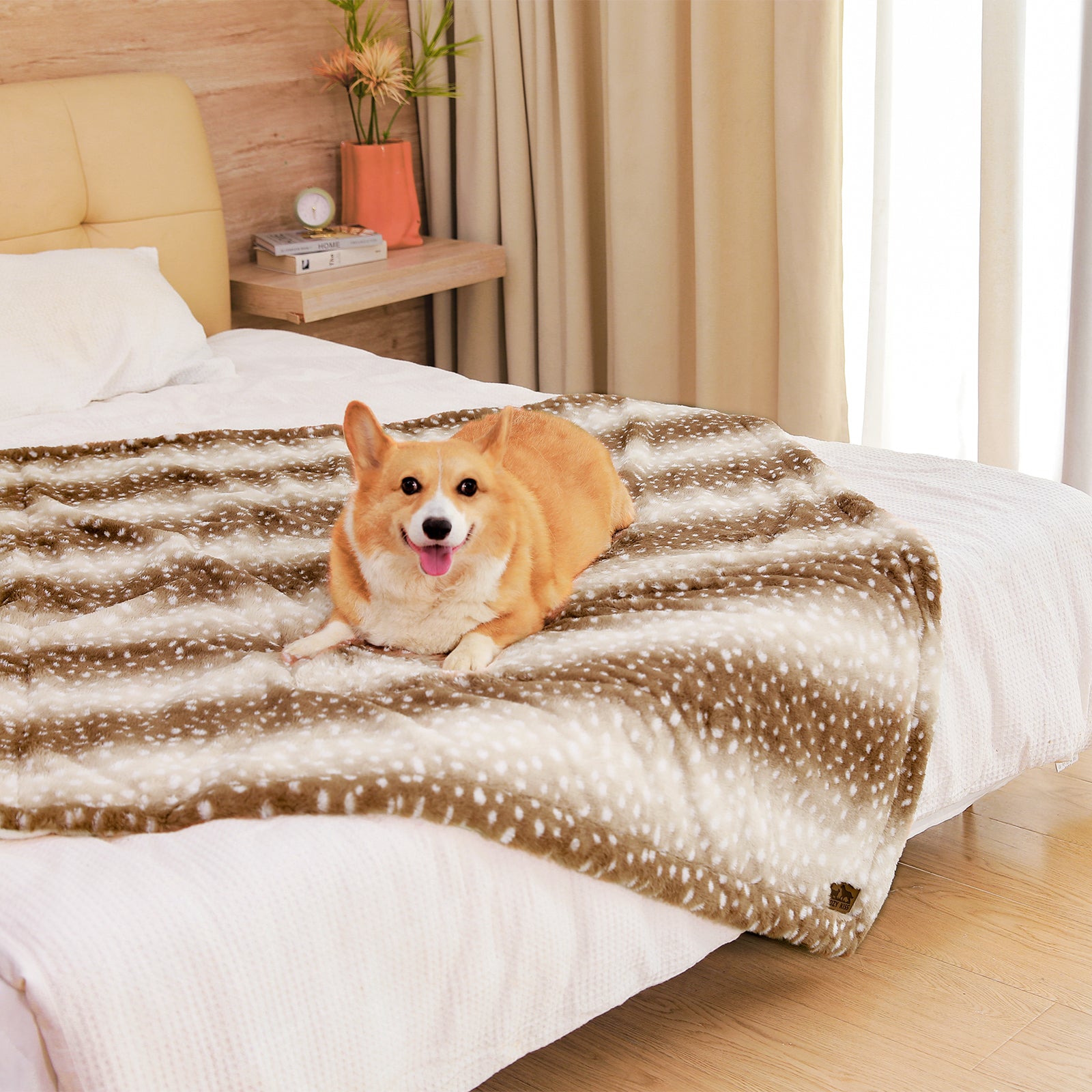 Cozy Kiss Stylish Deer Print Faux Fur Pet Blanket styled on a bed #color_Brown