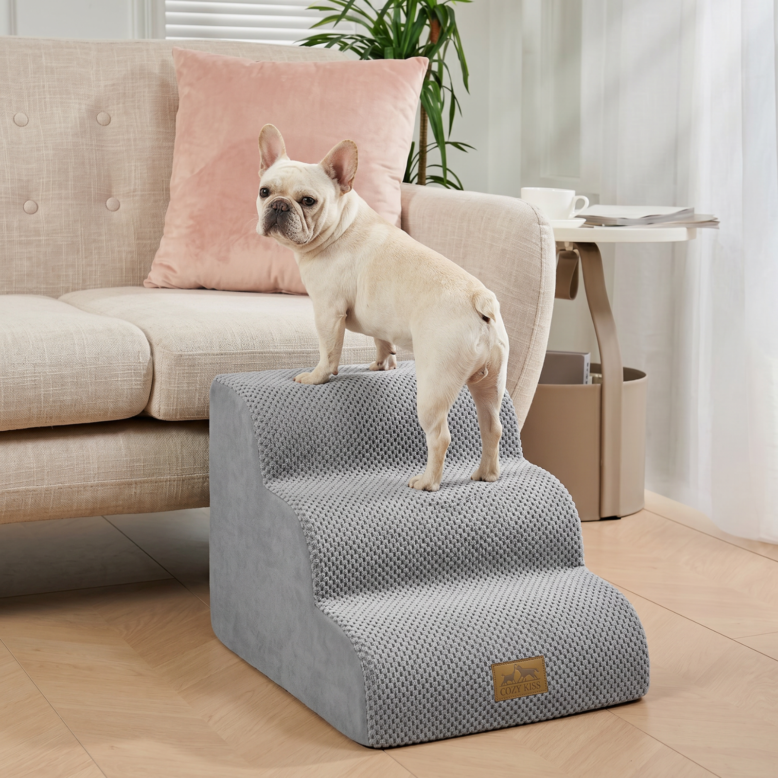 Cozy Kiss 3-Step Gentle Slope Curved Pet Stairs beside a sofa with a dog demonstrating easy and comfortable climbing access #color_Gray