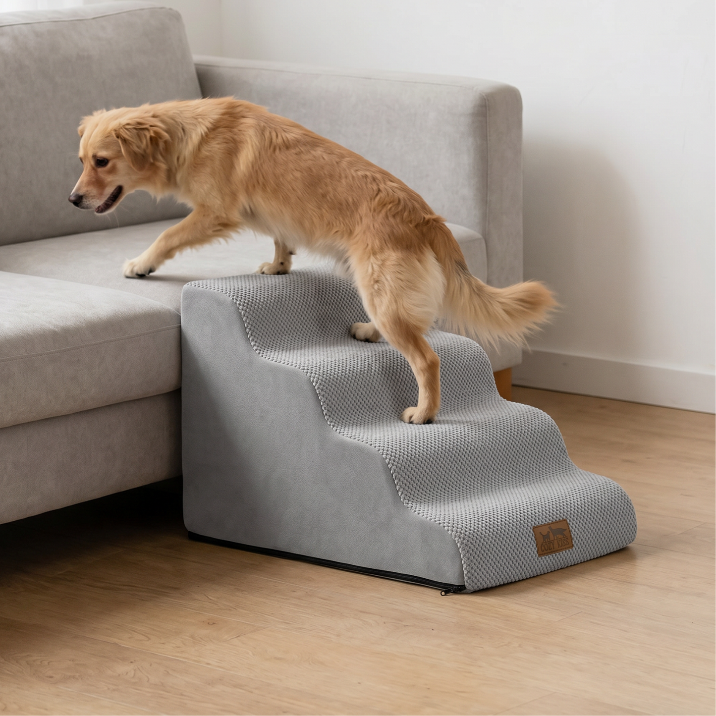 Cozy Kiss 4-Step Gentle Slope Curved Pet Stairs beside a sofa with a dog demonstrating easy and comfortable climbing access #color_Gray